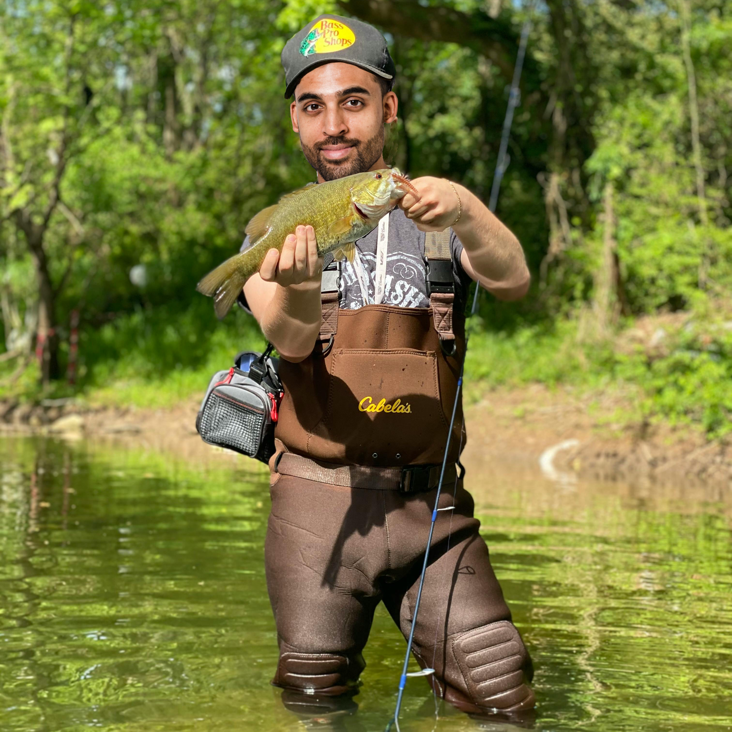 Man holding a fish in a river