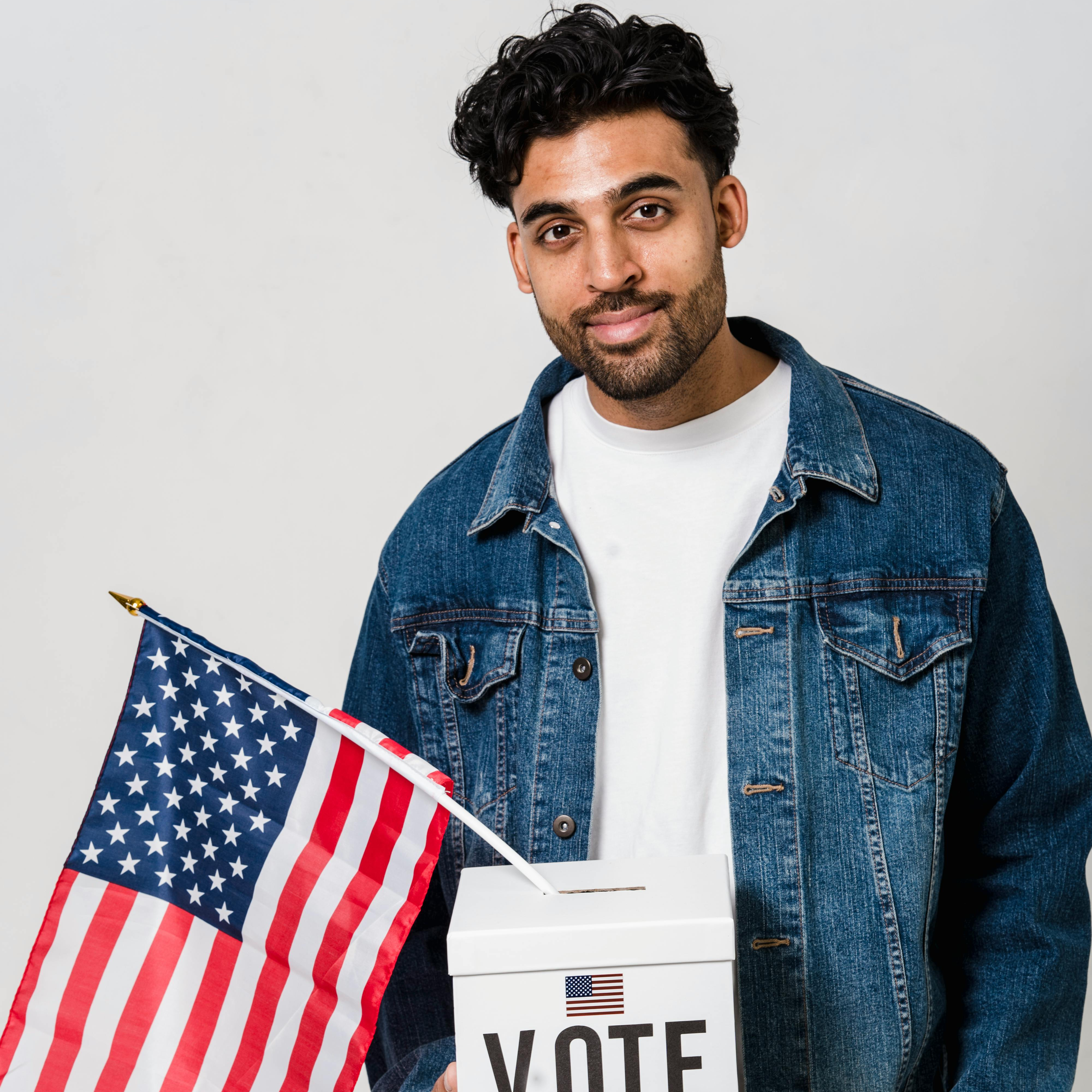 Man holding a ballot box and American flag