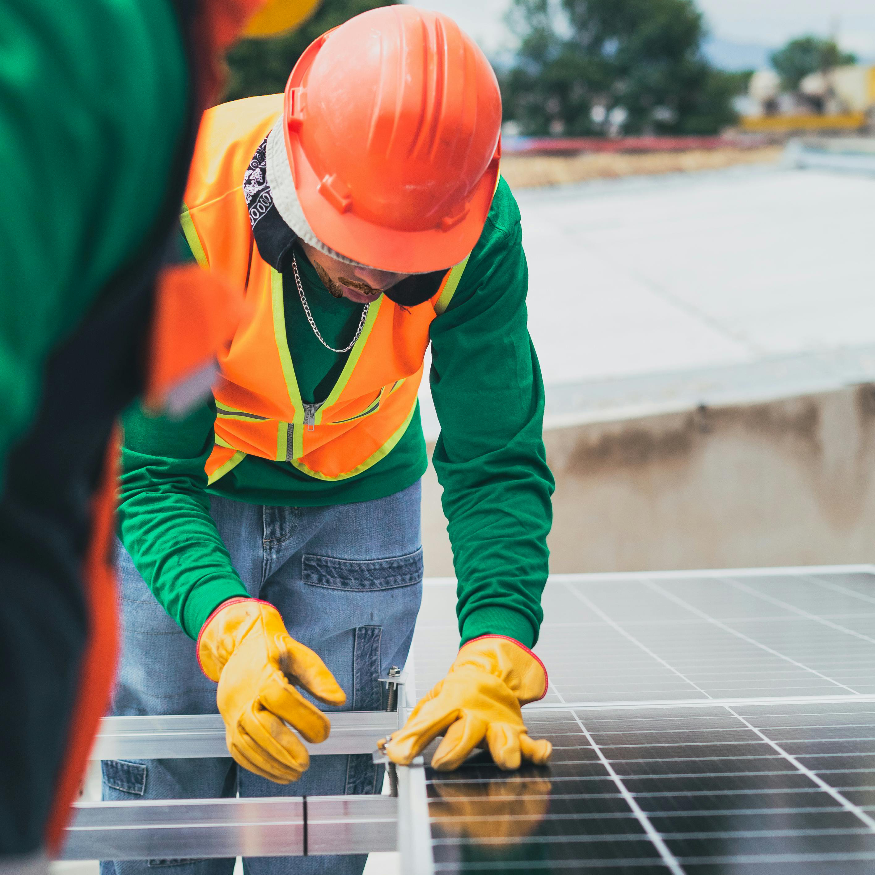 Man hunched over solar panels